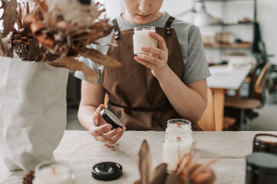 candid portrait of candle maker in rustic studio space